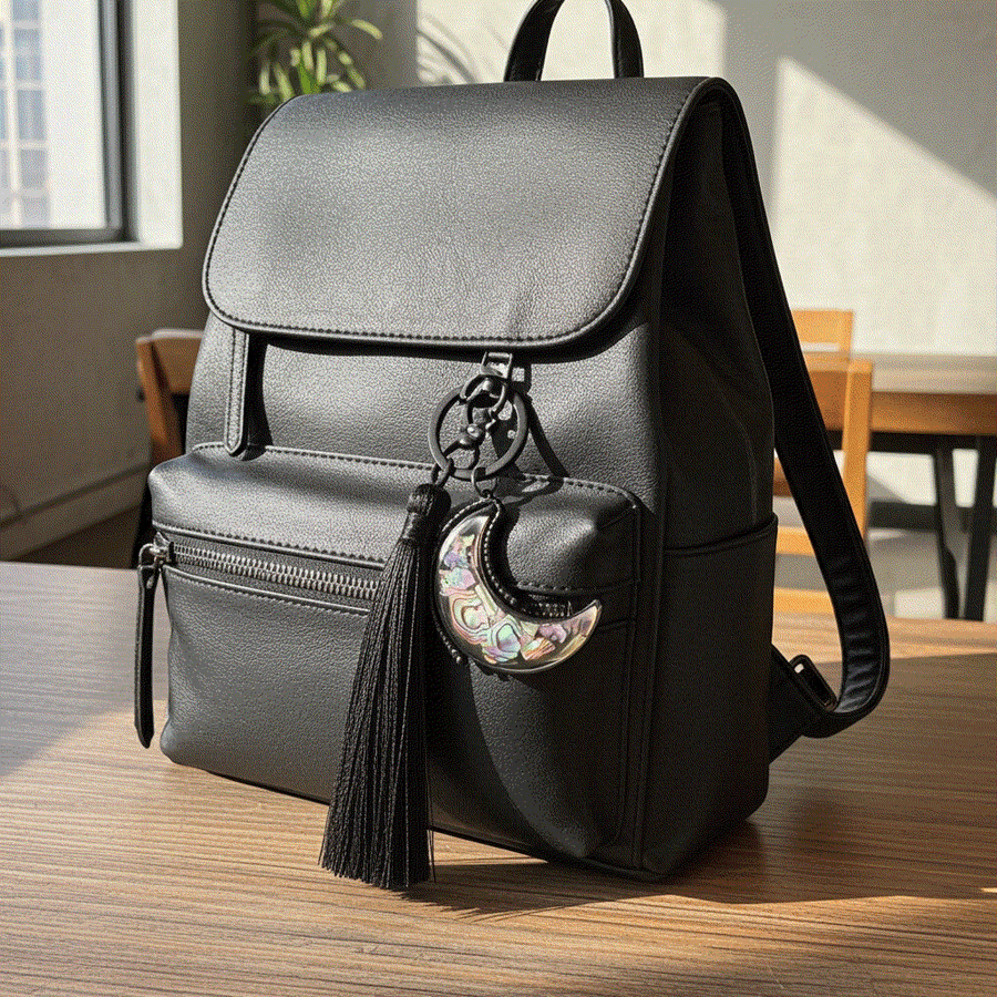 moon bag charm on black handbag