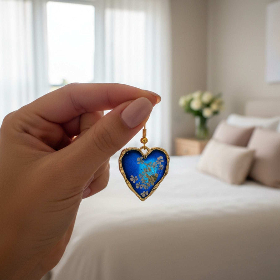 Handmade Pressed White Flower Earrings with a blue base