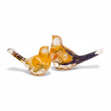 Close-up of real daffodil petals and purple crocus preserved in warm gold hand-poured resin bird