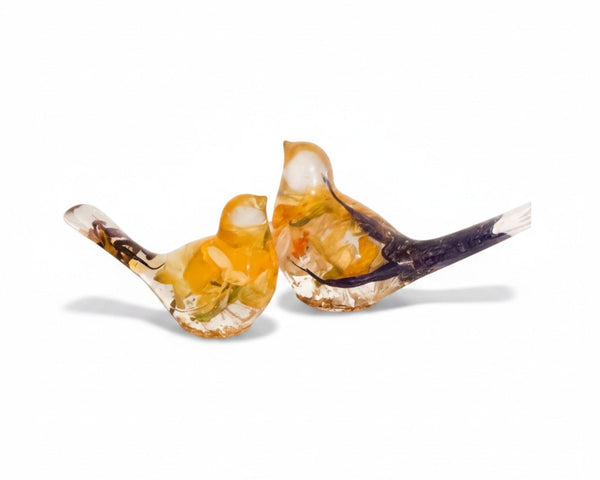 Close-up of real daffodil petals and purple crocus preserved in warm gold hand-poured resin bird