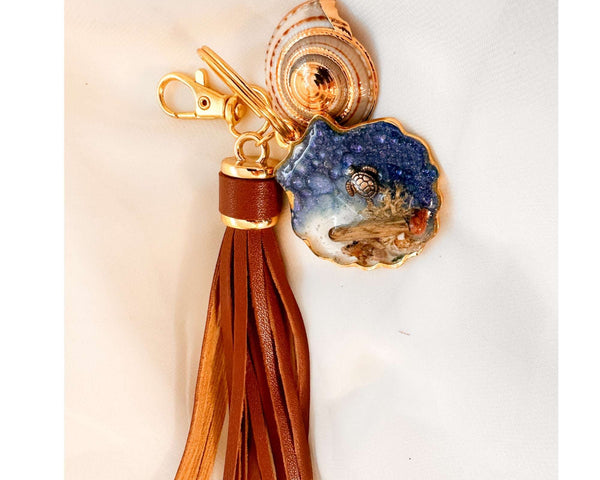 Handmade "Coastal Embrace" Keychain ($42): Real sand, seashells, & a silver turtle in glittering blue resin. Unique, luxury leather tassel & gold charm.