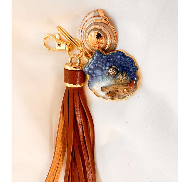 Handmade "Coastal Embrace" Keychain ($42): Real sand, seashells, & a silver turtle in glittering blue resin. Unique, luxury leather tassel & gold charm.