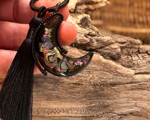 Northern Lights Keychain with a black crescent moon frame, shell mosaic inlay and long black tassel