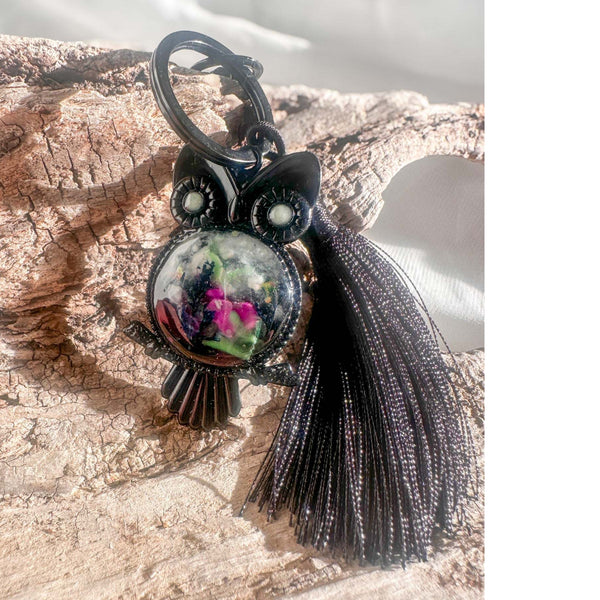 Close-up of handmade owl bag charm showing Northern Lights resin cabochon with pressed ferns