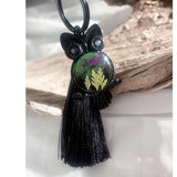Close-up of handmade owl bag charm showing Northern Lights resin cabochon with pressed ferns