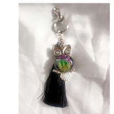 Northern Lights owl keychain with real ferns in resin and black tassel on white background