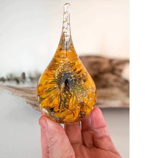 Holding a handmade resin ring holder with real black-eyed susan and sunflower with gold leaf accents