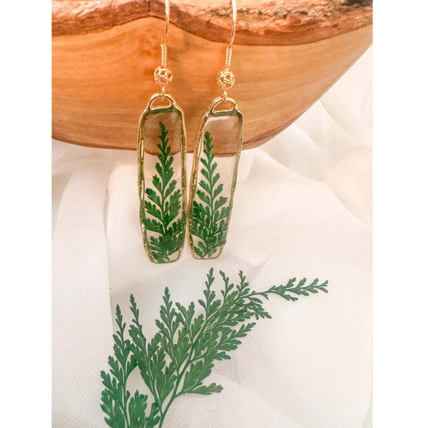 Handcrafted Fern's Embrace drop earrings featuring real green fern fronds in a clear resin setting.