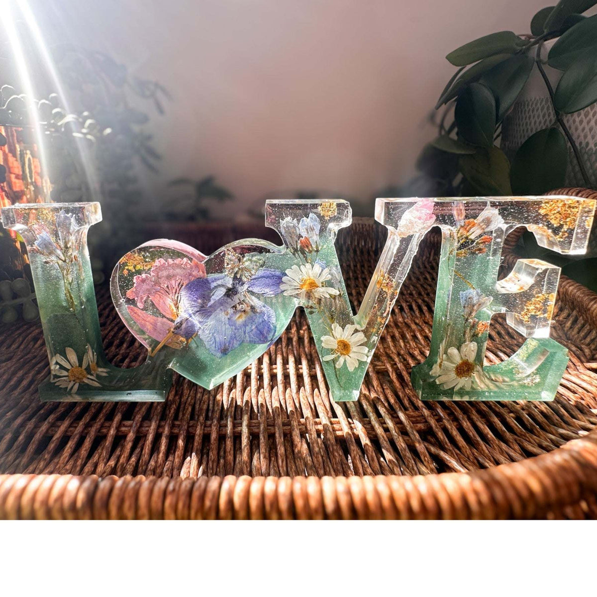 Handcrafted "LOVE" floral resin sign with deep green and clear layers.