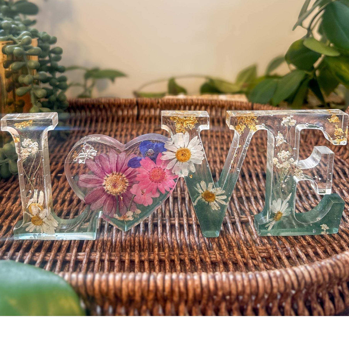 Handcrafted floral resin LOVE sign with a large pink cosmo and forest green base.