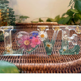 Handcrafted floral resin LOVE sign with a large pink cosmo and forest green base.