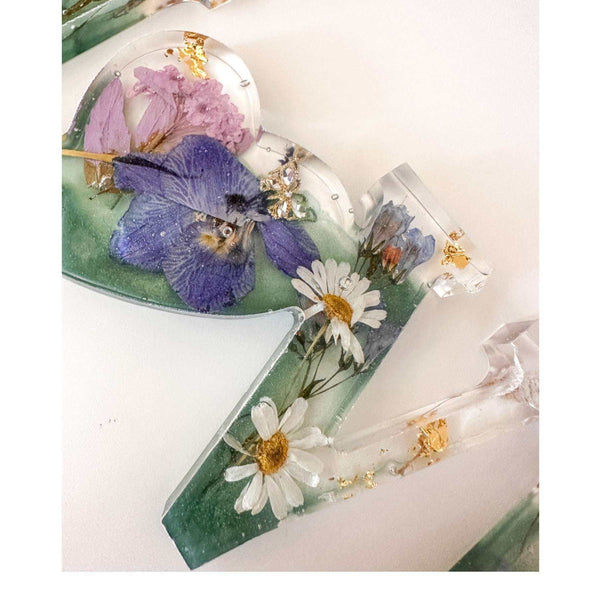 Handcrafted "LOVE" floral resin sign with deep green and clear layers.