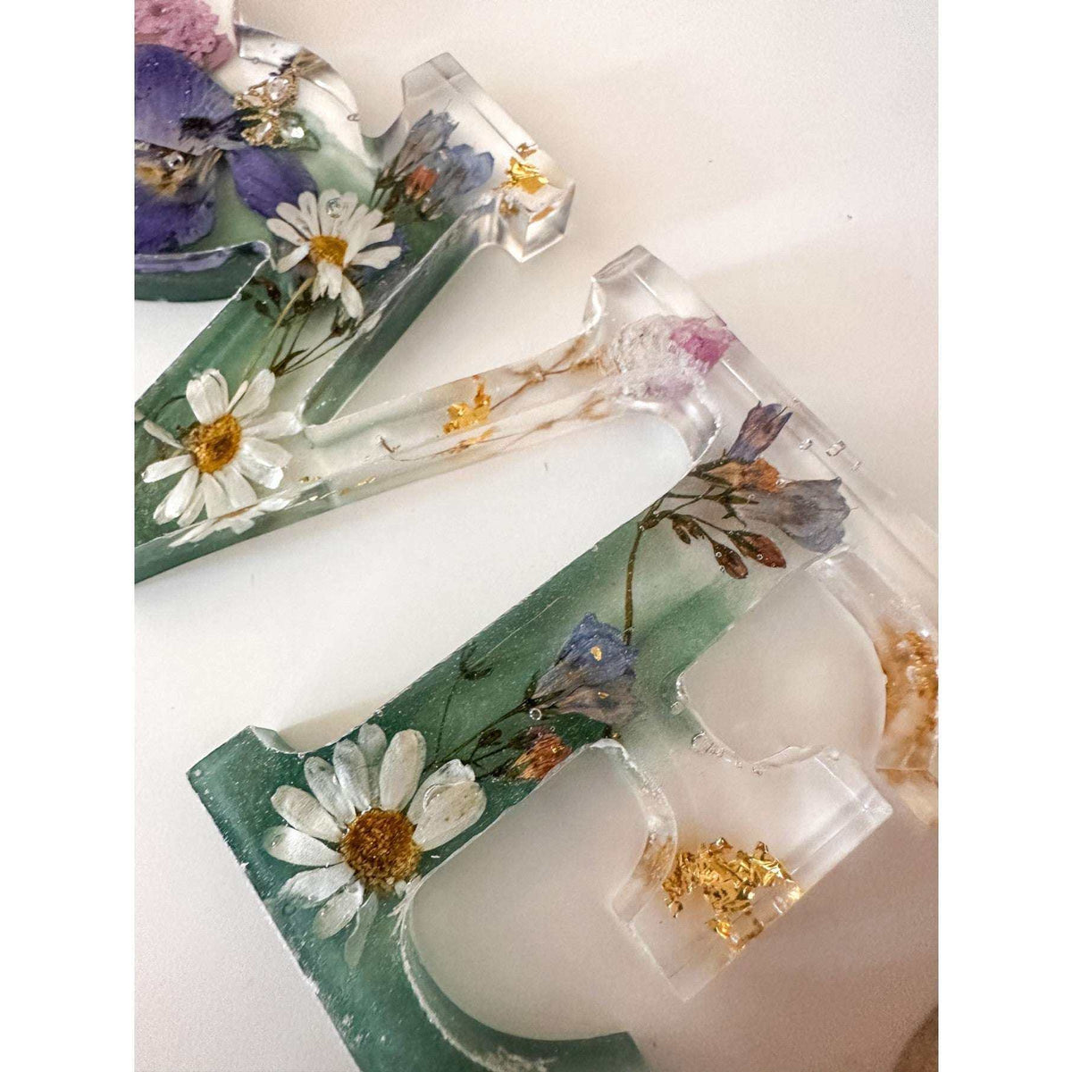 Handcrafted "LOVE" floral resin sign with deep green and clear layers.
