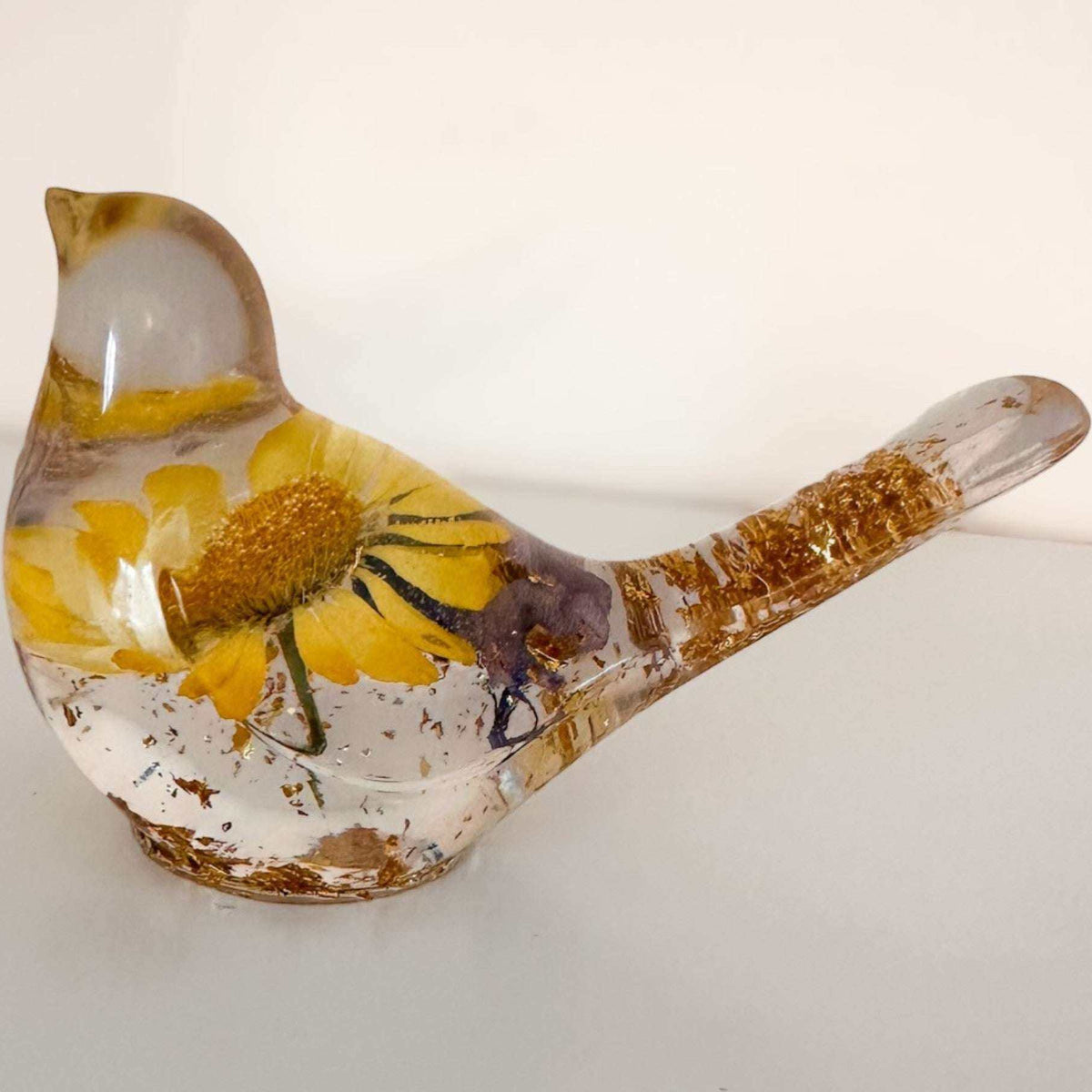 Handcrafted yellow floral resin bird with a real yellow daisy and gold leaf