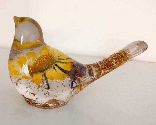 Handcrafted yellow floral resin bird with a real yellow daisy and gold leaf
