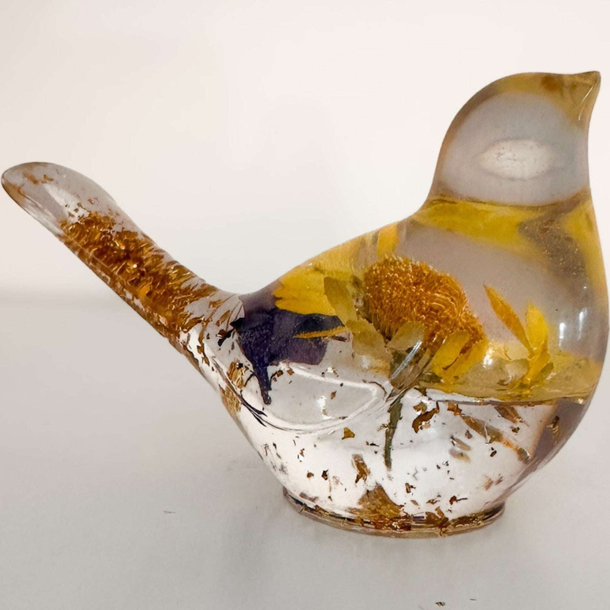 Handcrafted yellow floral resin bird with a real yellow daisy and gold leaf