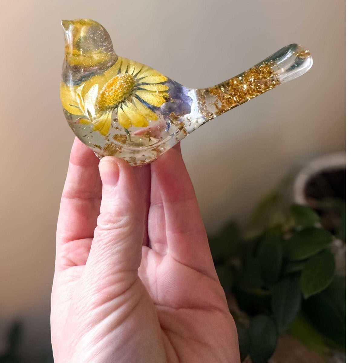 Handcrafted yellow floral resin bird with a real yellow daisy and gold leaf