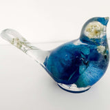 Close up of real blue rose petals and white baby's breath inside a Blue Rose Resin Bird.