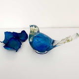 Close up of real blue rose petals and white baby's breath inside a Blue Rose Resin Bird.