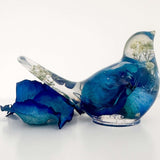 Close up of real blue rose petals and white baby's breath inside a Blue Rose Resin Bird.
