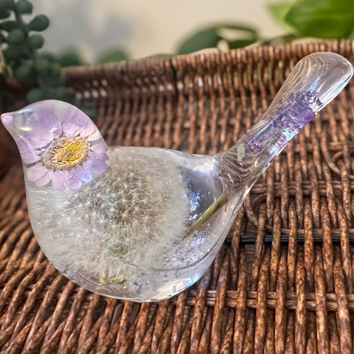 Handcrafted Purple Petal Dandelion Resin Bird with preserved fairy wishes on a wicker background.