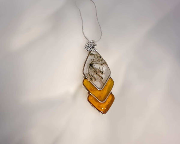 Capture nature's beauty with this exquisite honey bee themed pendant, crafted with real pressed flowers encased in honey-tinted resin. Handmade and one of a kind