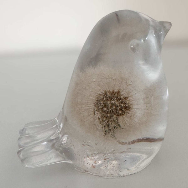 Wish Keeper Songbird dandelion resin bird on a sunny surface catching natural light