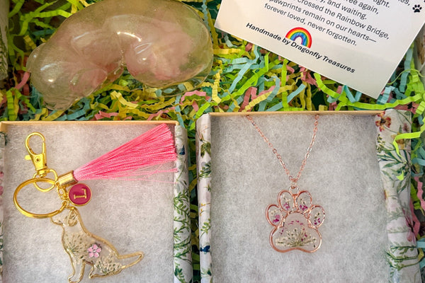 Gift set with paw-shaped soap, keychain, and necklace in a decorative box.