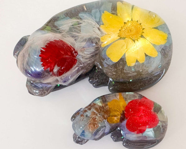 Handmade custom resin memorial pet figurine of resting dog with floral inclusions and personalized ashes and fur keepsake