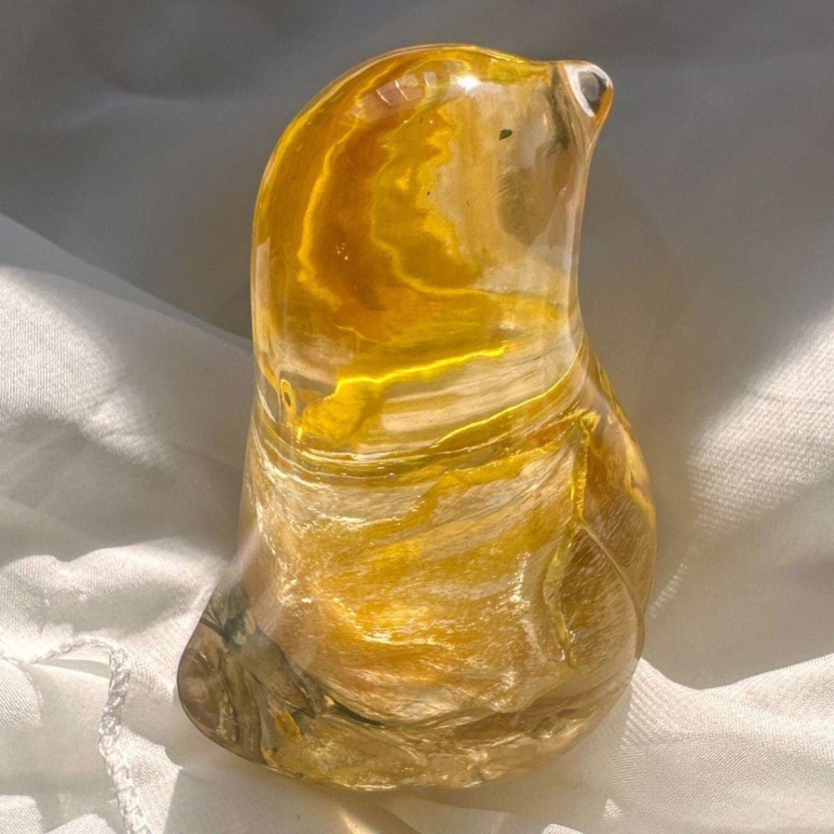 Close-up of real yellow rose bud with golden outer petals and cream inner petals preserved in clear hand-poured resin bird