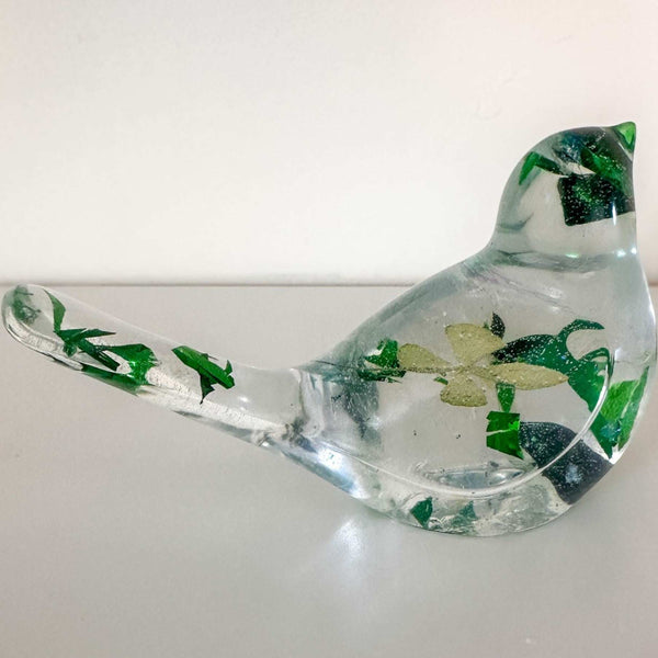 Clear resin bird figurine filled with real green four leaf clovers, vibrant green botanicals, and gold flakes,
