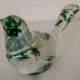 Clear resin bird figurine filled with real green four leaf clovers, vibrant green botanicals, and gold flakes,