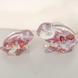 Small and large Blossom and Burrow pink floral resin bunny decor set displayed together on a shelf