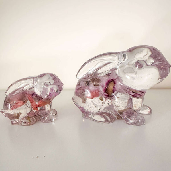 Small and large Blossom and Burrow pink floral resin bunny decor set displayed together on a shelf
