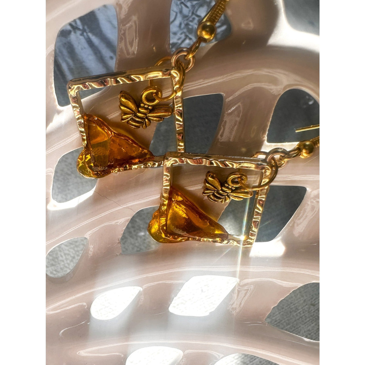 Handmade honey bee drip earrings with gold bee charm & hypoallergenic hooks. One of a kind, made in Cold Lake, Alberta.