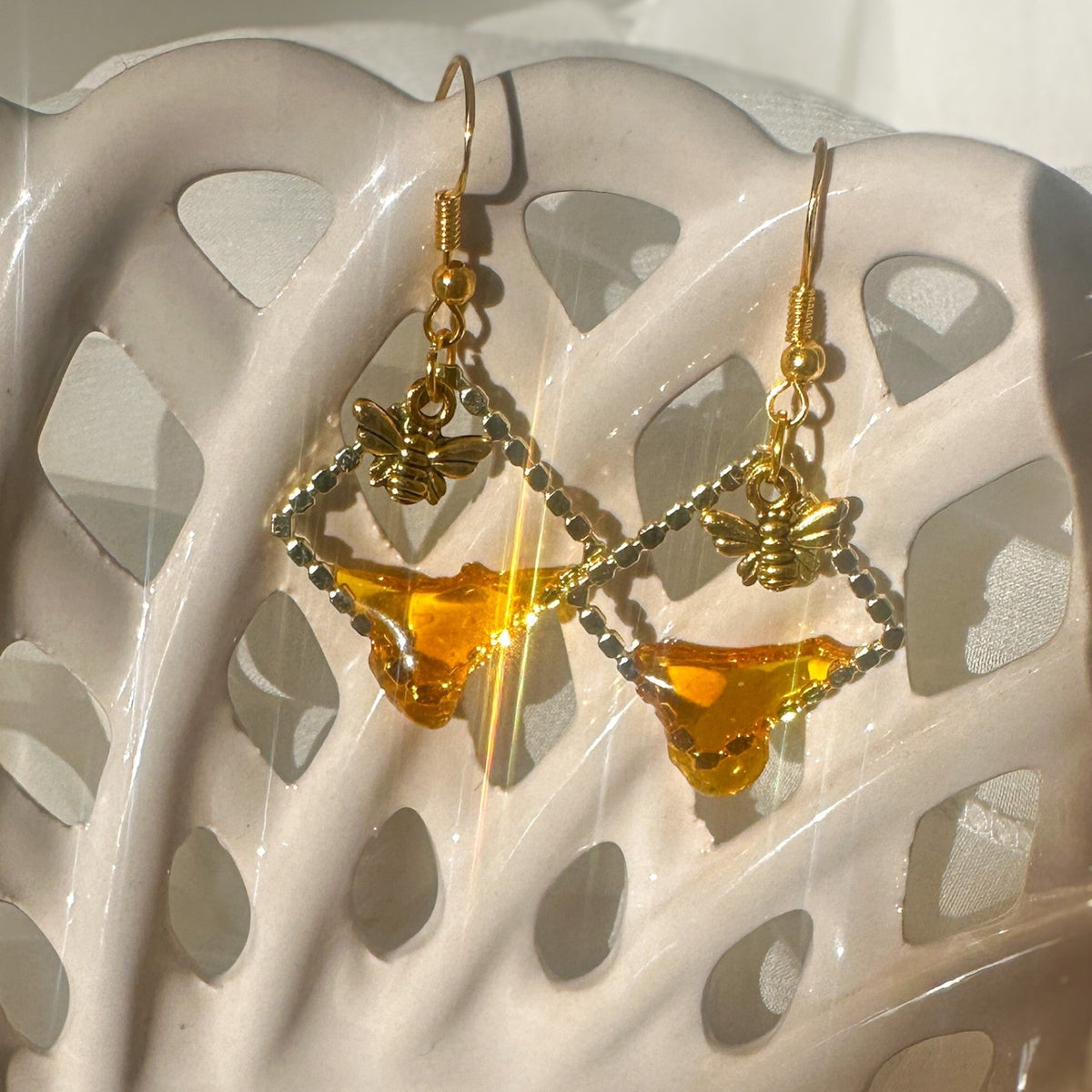 Handmade honey bee drip earrings with gold bee charm & hypoallergenic hooks. One of a kind, made in Cold Lake, Alberta.