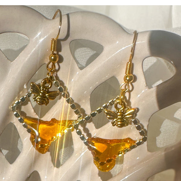 Handmade honey bee drip earrings with gold bee charm & hypoallergenic hooks. One of a kind, made in Cold Lake, Alberta.