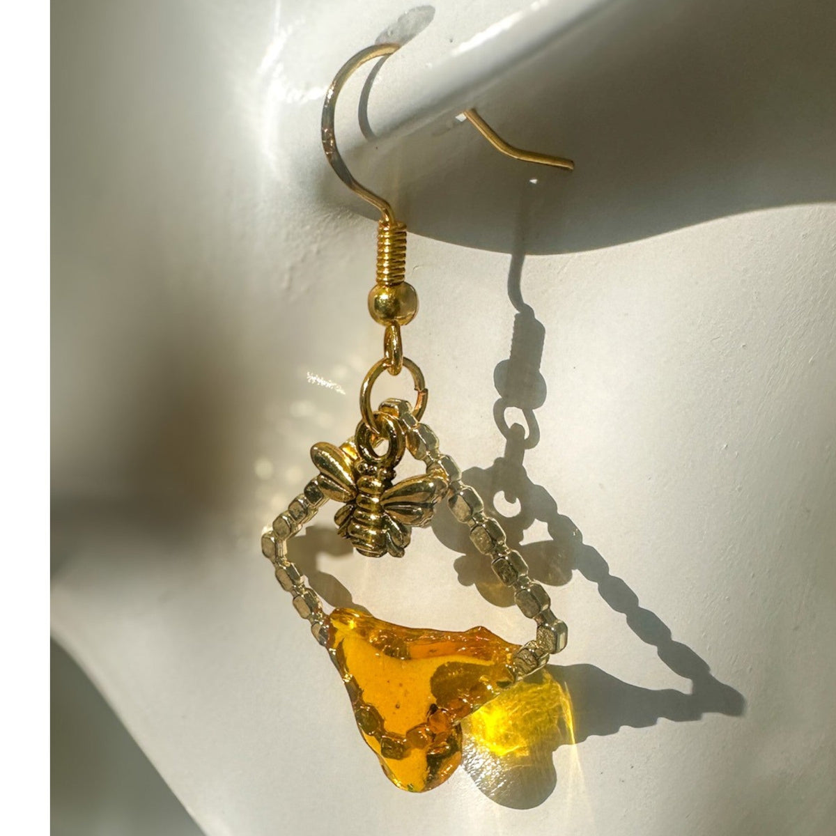 Handmade honey bee drip earrings with gold bee charm & hypoallergenic hooks. One of a kind, made in Cold Lake, Alberta.