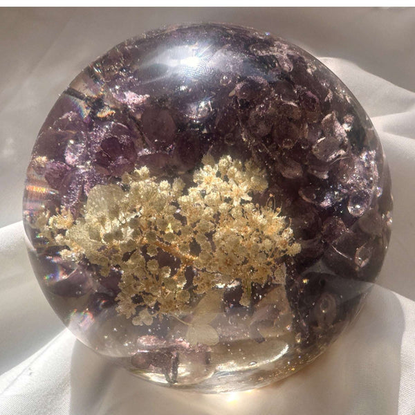 Purple lilac resin sphere with real lilac and hydrangea blooms glowing on LED light base