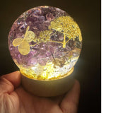 Purple lilac resin sphere with real lilac blooms and white hydrangea on LED light base