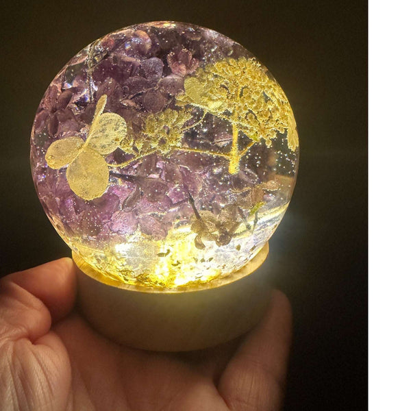 Purple lilac resin sphere with real lilac blooms and white hydrangea on LED light base