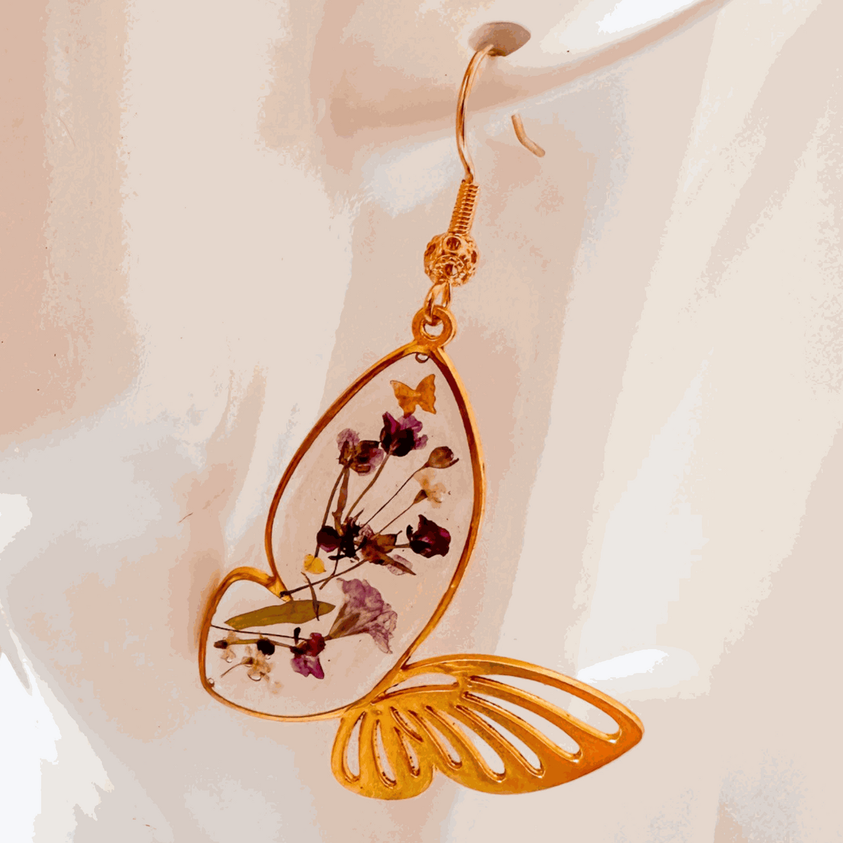 Fluttering Blossom handmade earrings with real pressed flowers encased in resin butterfly wings and dainty butterfly accents