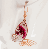 Rose gold Garden Wing Earrings with pressed deep pink and white flowers in resin butterfly wings and gold butterfly accent