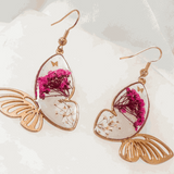 Rose gold Garden Wing Earrings with deep pink and white pressed flower butterfly wings encased in resin, lightweight and hypoallergenic