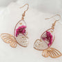 Garden Butterfly Wing Earrings with pressed deep pink and white flowers encased in resin butterfly wings and gold butterfly accents.