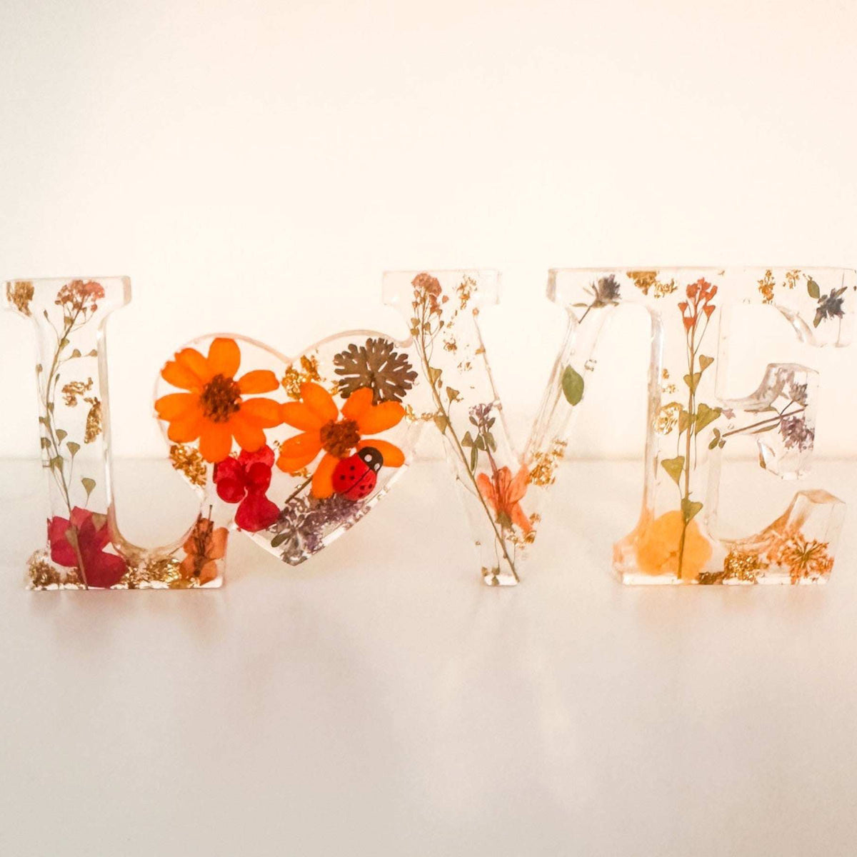 Pressed flower resin LOVE word art with real wildflowers and ladybug accent