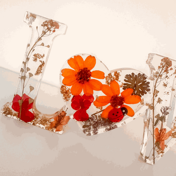 Pressed flower resin decor LOVE word art with real pressed wildflowers and tiny ladybug in clear resin letters