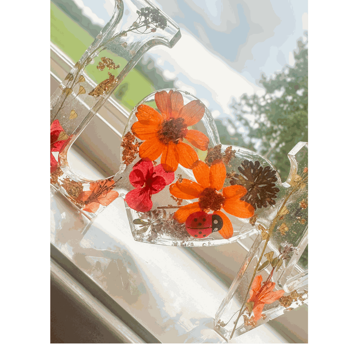 Pressed flower resin decor LOVE word art with real orange and red blooms and ladybug accent