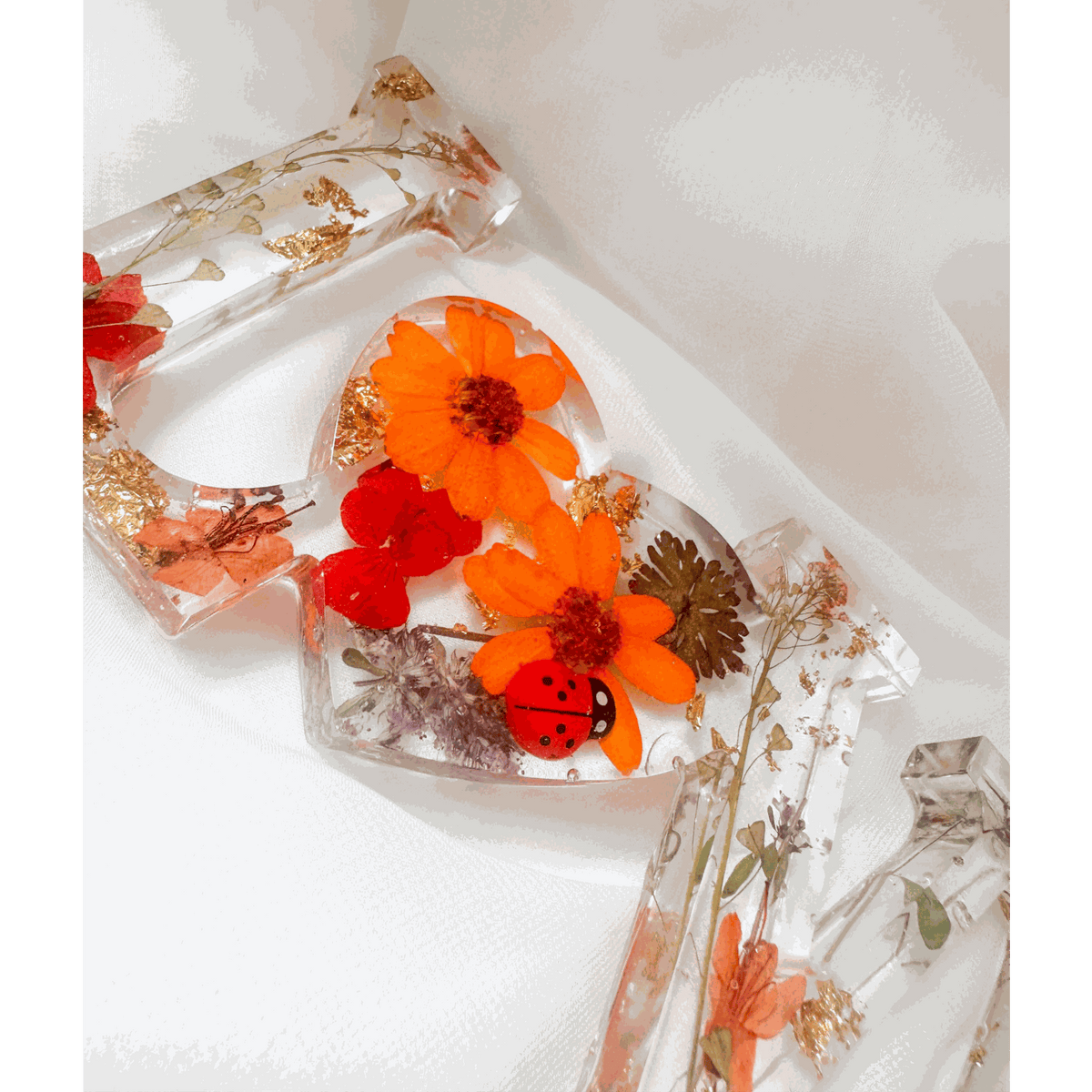 Pressed flower resin decor LOVE word art with real wildflowers and ladybug accents in clear resin letters