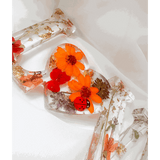 Pressed flower resin decor LOVE word art with real wildflowers and ladybug accents in clear resin letters